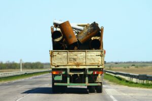 A truck carrying what looks to be improperly secured cargo, creating the risk of a trucking accident