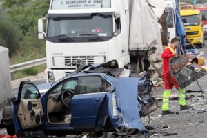 Emergency services personnel cleaning debris from the roadway after a semi-truck accident; potential semi-truck accident lawyer scenario.