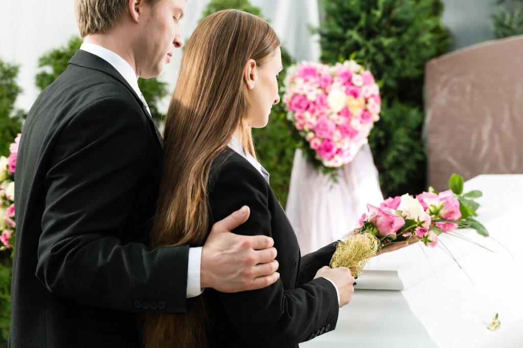 Grieving family members mourning an untimely death at a young person’s funeral; precursor to seeking wrongful death compensation.