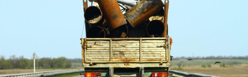 A truck carrying what looks to be improperly secured cargo, creating the risk of a trucking accident