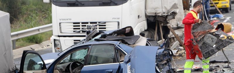 Emergency services personnel cleaning debris from the roadway after a semi-truck accident; potential semi-truck accident lawyer scenario.