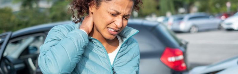 Woman experiencing neck pain after a car accident